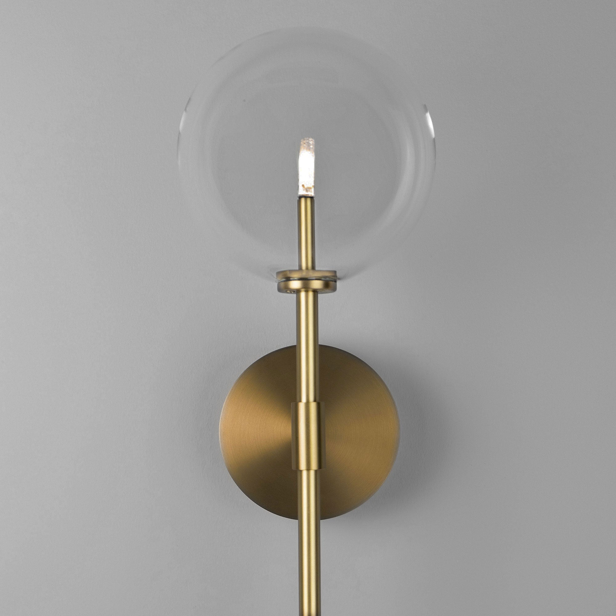Schwung Dawn Dual Burnished Brass Transparent Globe Wall Light